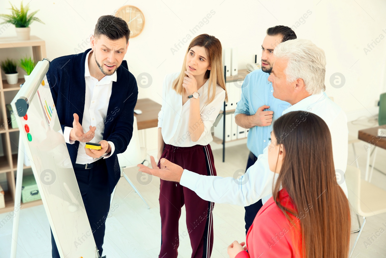 Photo of Office employees having argument during business meeting