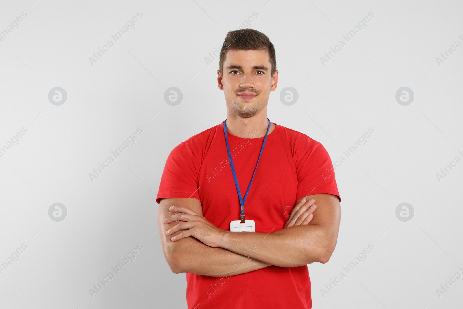 Photo of Portrait of happy young courier on white background