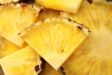 Photo of Pieces of tasty ripe pineapple as background, top view