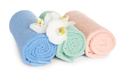 Photo of Clean soft towels with orchids isolated on white