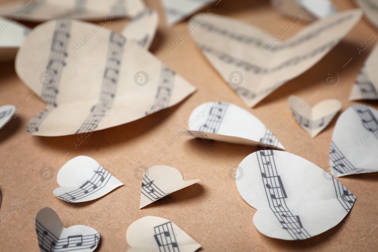 Photo of Paper hearts with music notes on color background