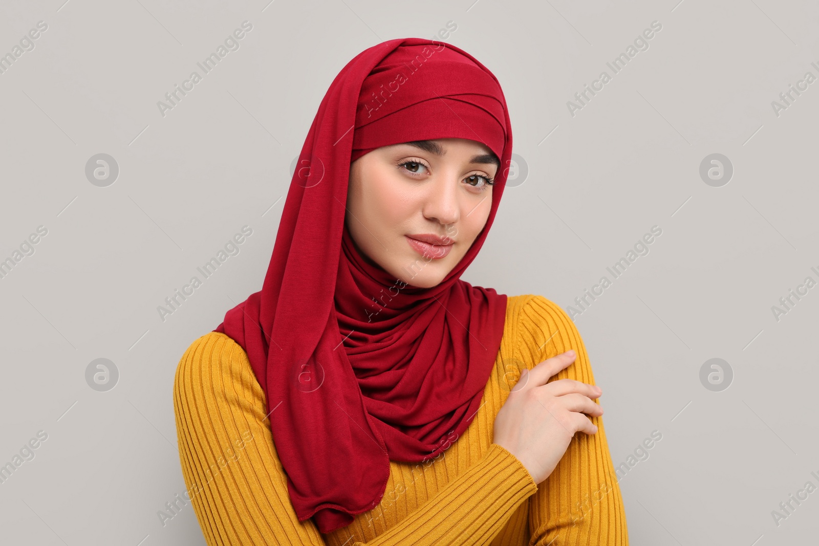 Photo of Portrait of Muslim woman in hijab on light gray background