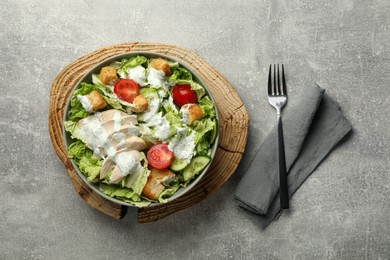 Photo of Delicious salad with Chinese cabbage, cucumber, meat and tomatoes served on grey table, flat lay