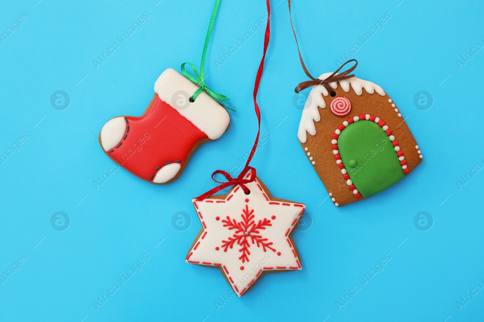 Photo of Different delicious Christmas cookies on light blue background, flat lay