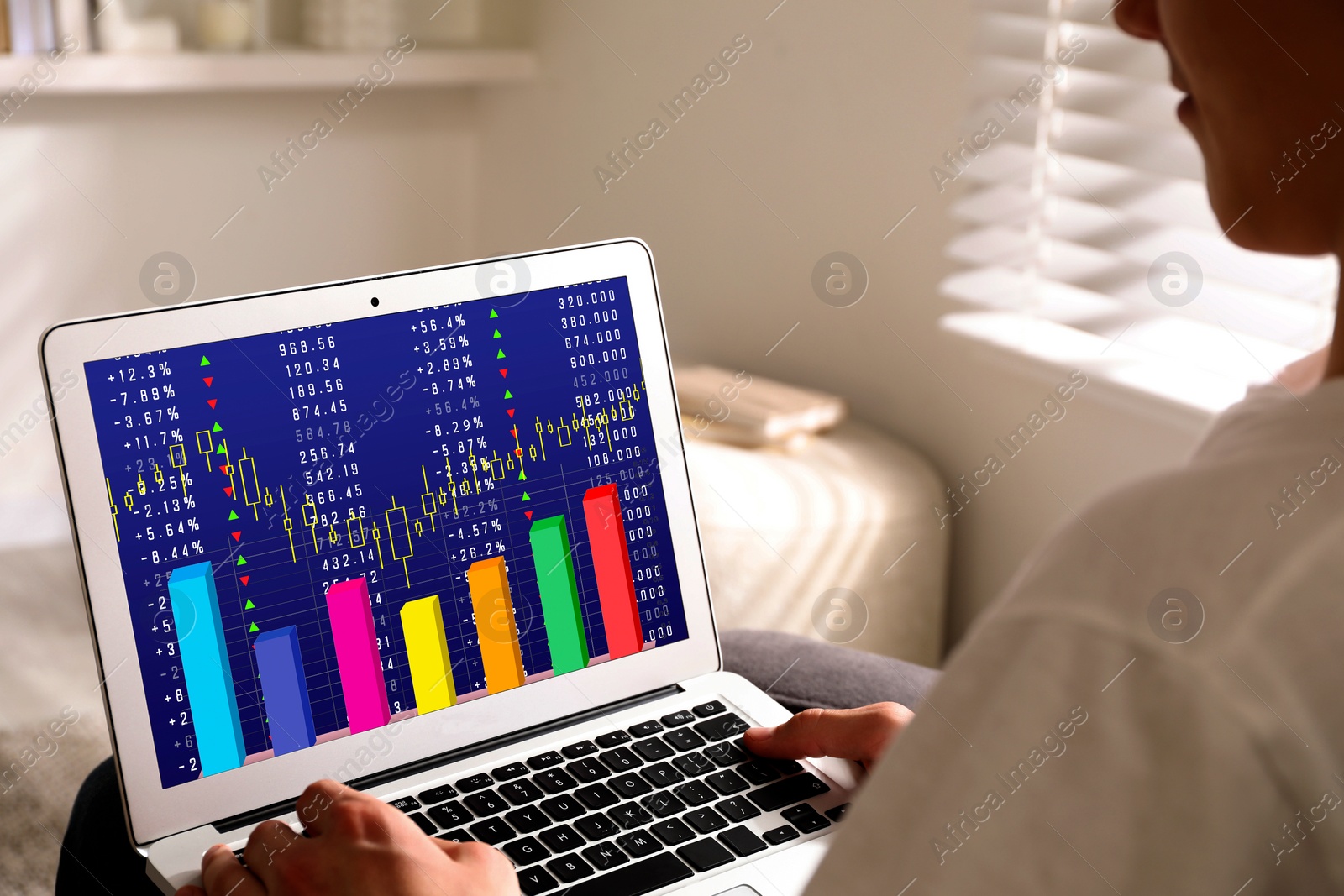 Image of Man analyzing situation on stock exchange market via laptop, closeup. Data and graph on screen