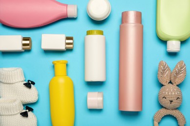 Flat lay composition with baby cosmetic products on light blue background