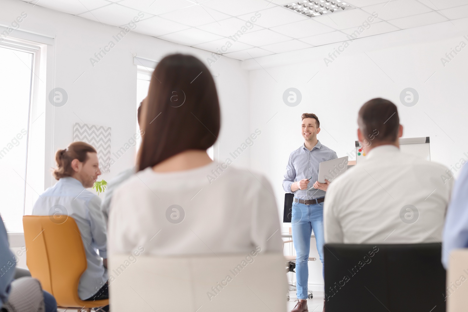 Photo of Male business trainer giving lecture in office