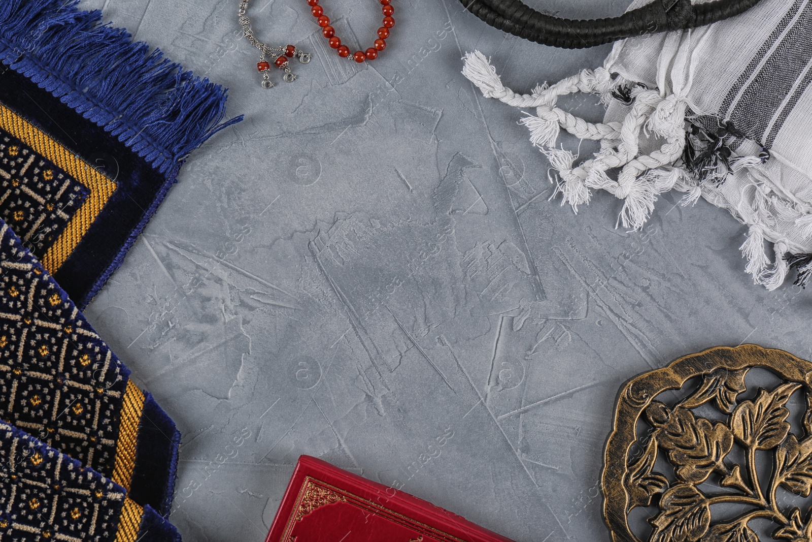 Photo of Flat lay composition with Muslim prayer beads, Quran and space for text on grey background