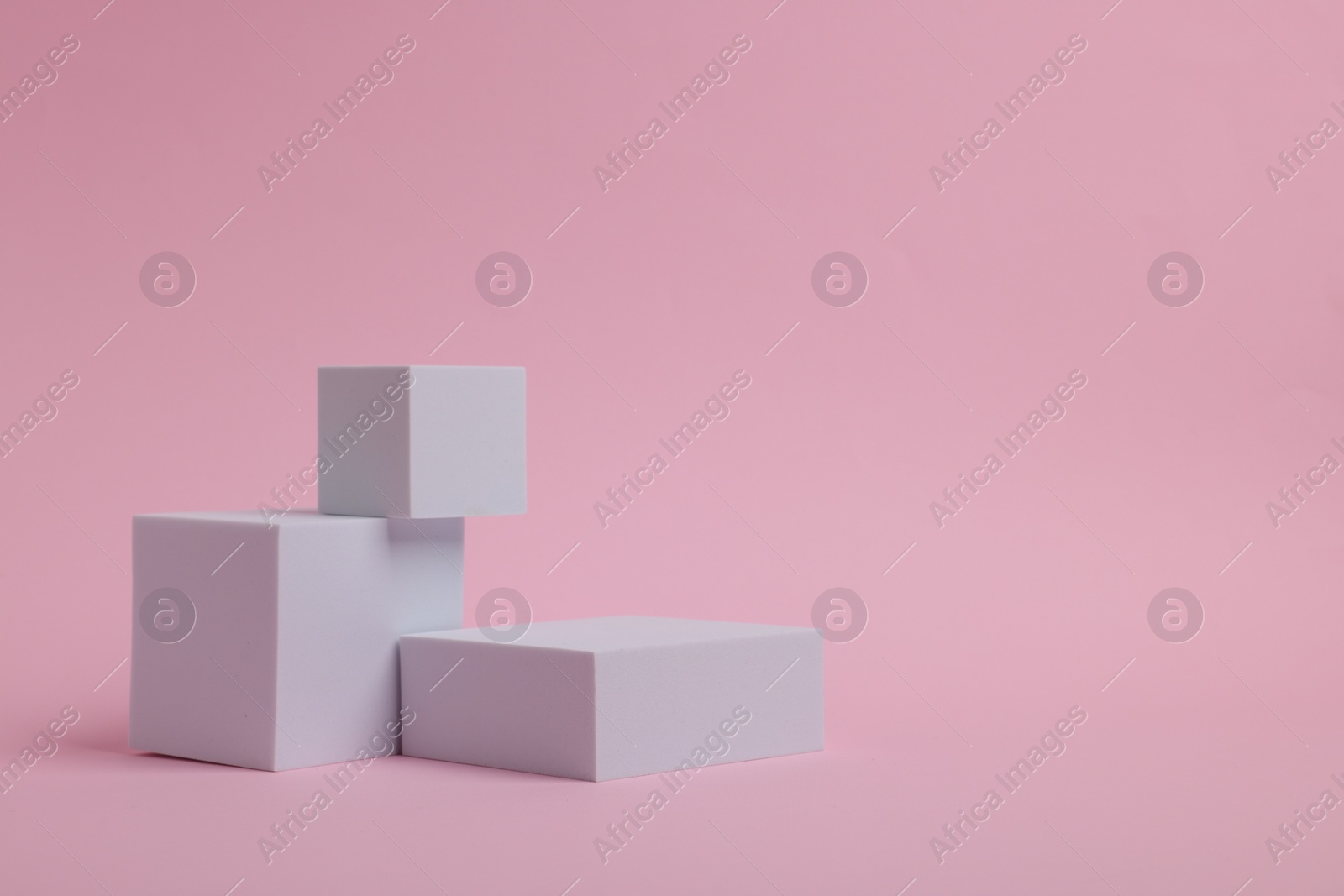 Photo of Scene for product presentation. Podiums of different geometric shapes on pink background, space for text