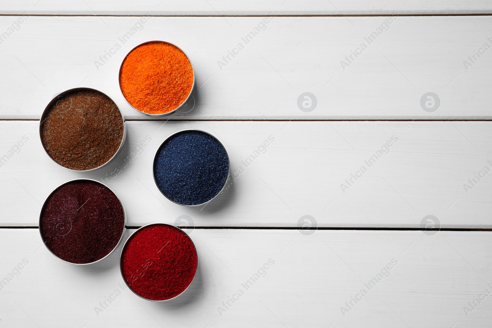 Photo of Different food coloring on white wooden table, flat lay. Space for text