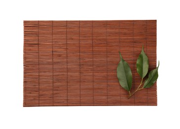 Photo of Sushi mat made of bamboo and leaves on white background, top view