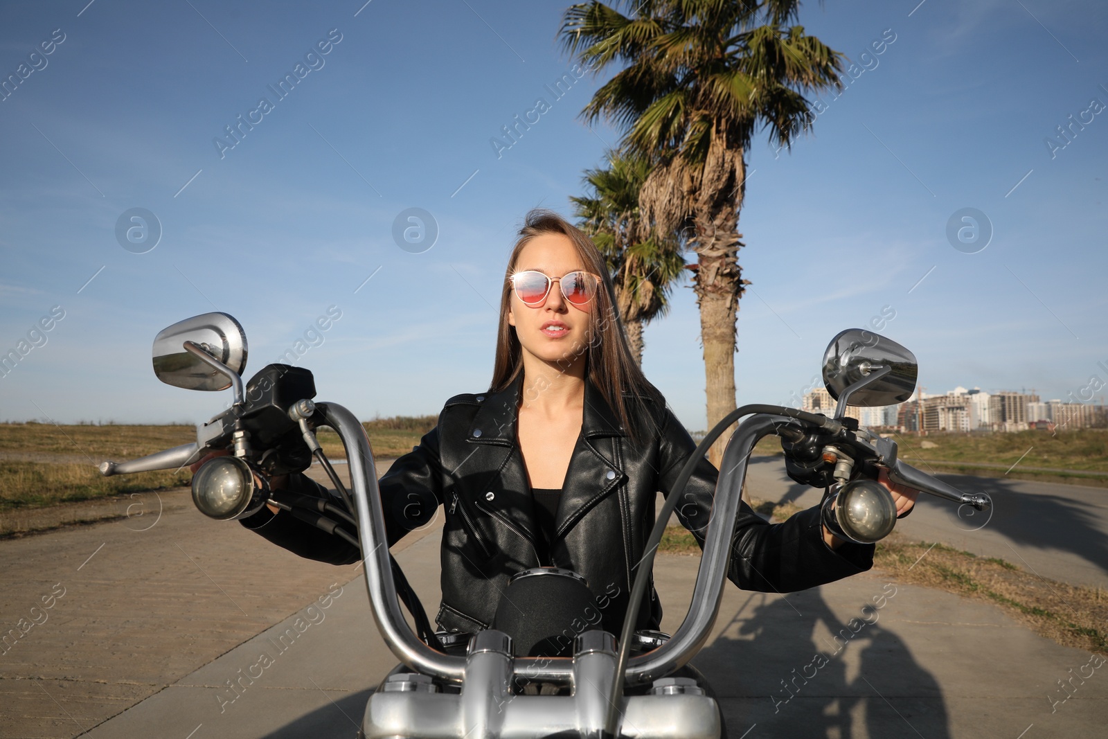 Photo of Beautiful woman riding motorcycle on sunny day