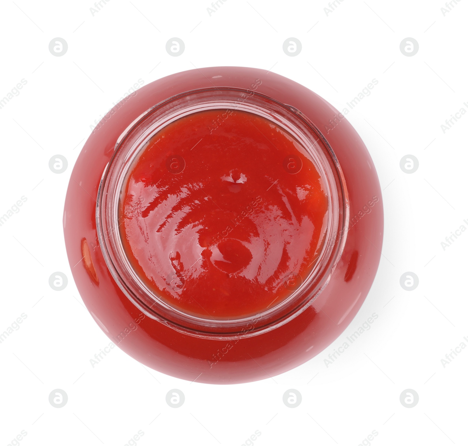 Photo of Organic ketchup in glass jar isolated on white, top view. Tomato sauce