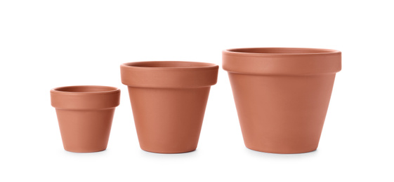 Photo of Stylish terracotta flower pots isolated on white