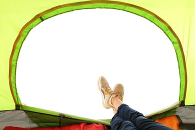 Photo of Closeup of female in camping tent on white background, view from inside