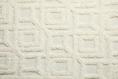 Texture of beautiful white carpet as background, top view