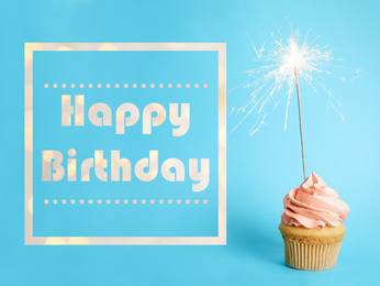 Image of Text Happy Birthday and delicious cupcake with sparkler on light blue background