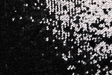 Beautiful dark sequin fabric as background, top view