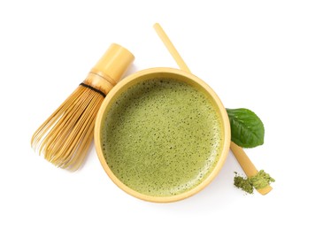 Photo of Cup of fresh green matcha tea, bamboo whisk and spoon isolated on white, top view