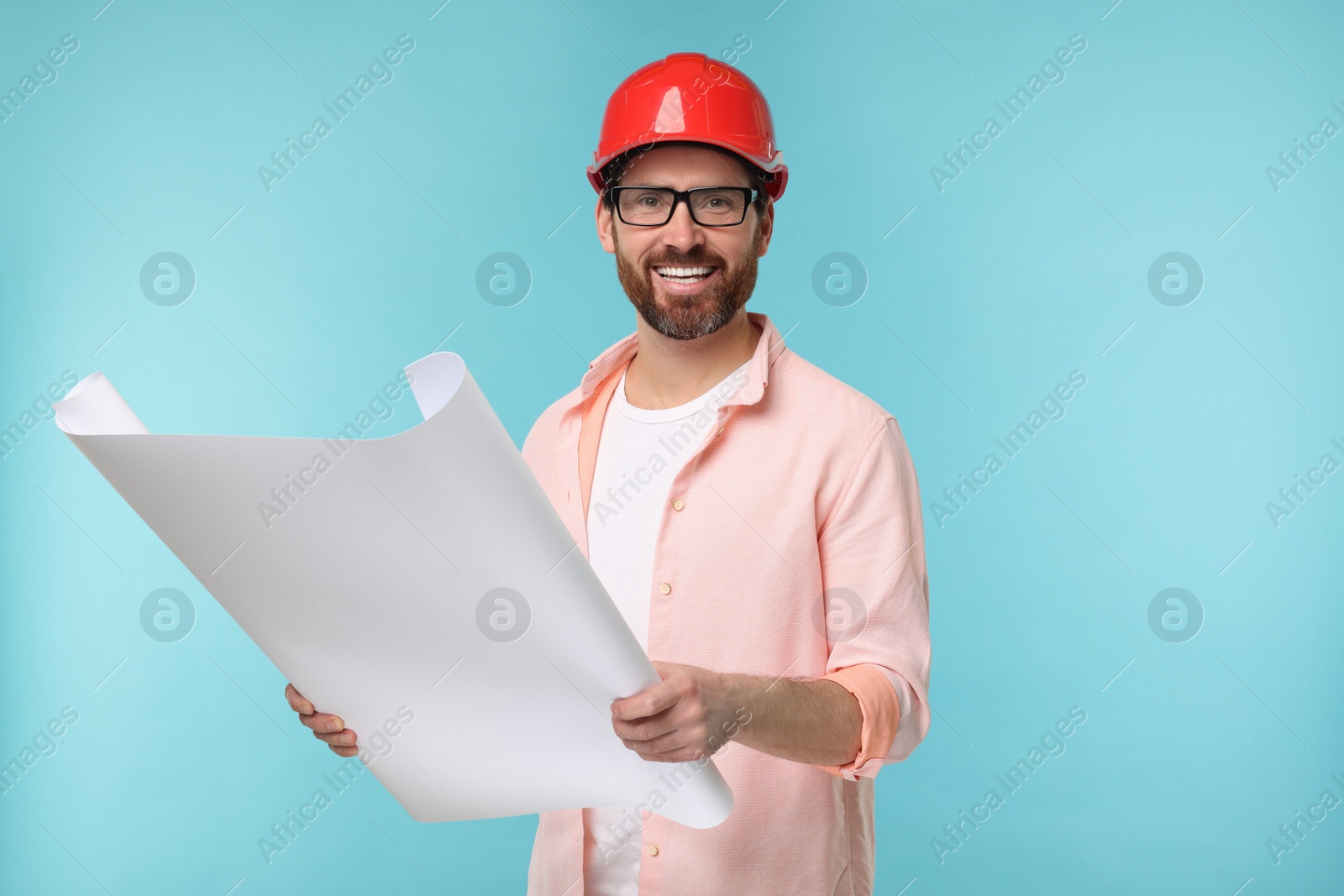 Photo of Architect in hard hat with draft on light blue background