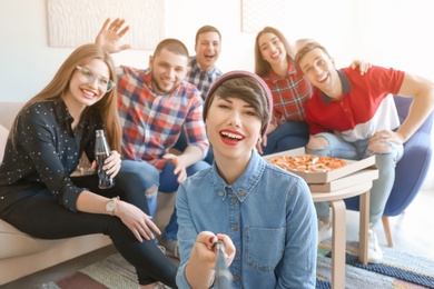 Happy friends taking selfie indoors