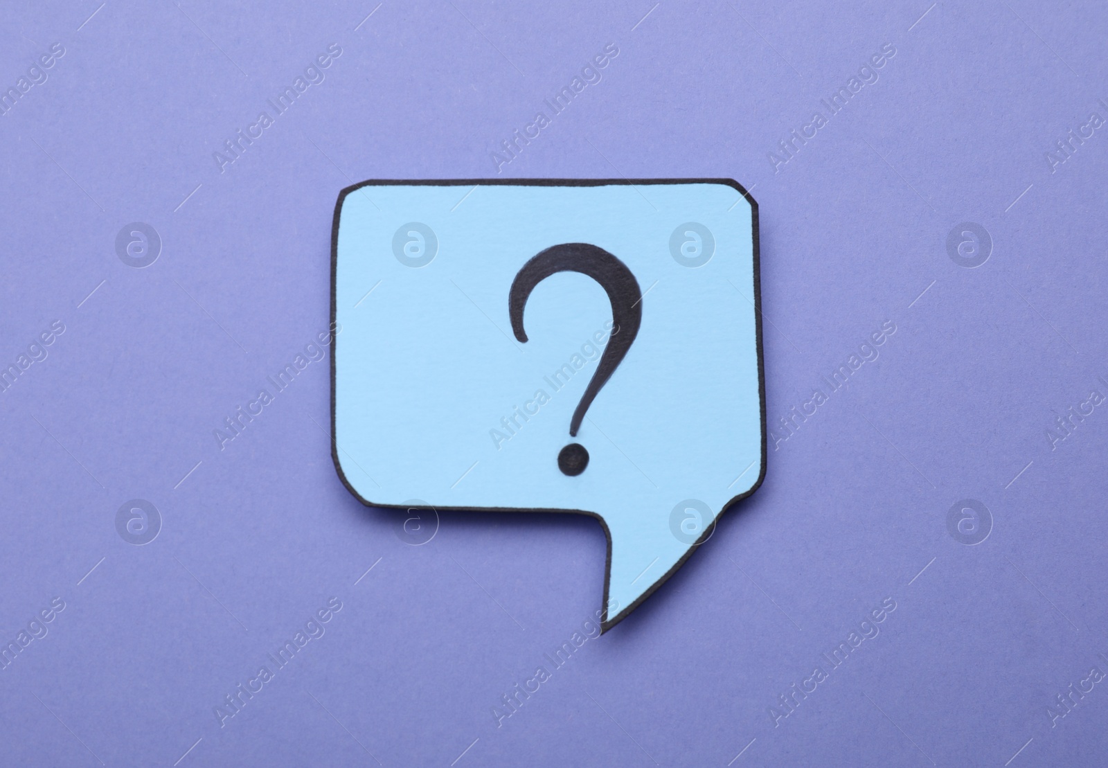 Photo of Paper speech bubble with question mark on violet background, top view