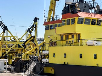 Photo of Ship moored in sea port on sunny day