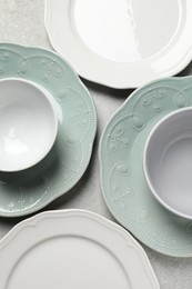 Beautiful ceramic dishware on light grey table, flat lay