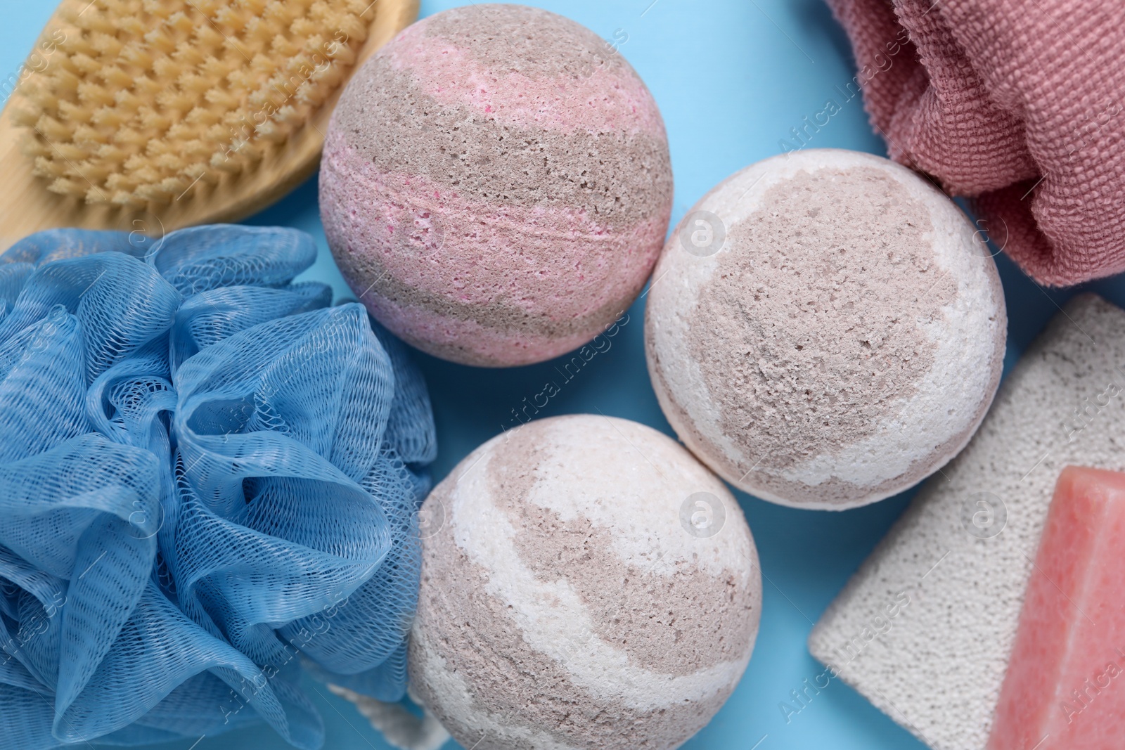 Photo of Flat lay composition with bath bombs on light blue background