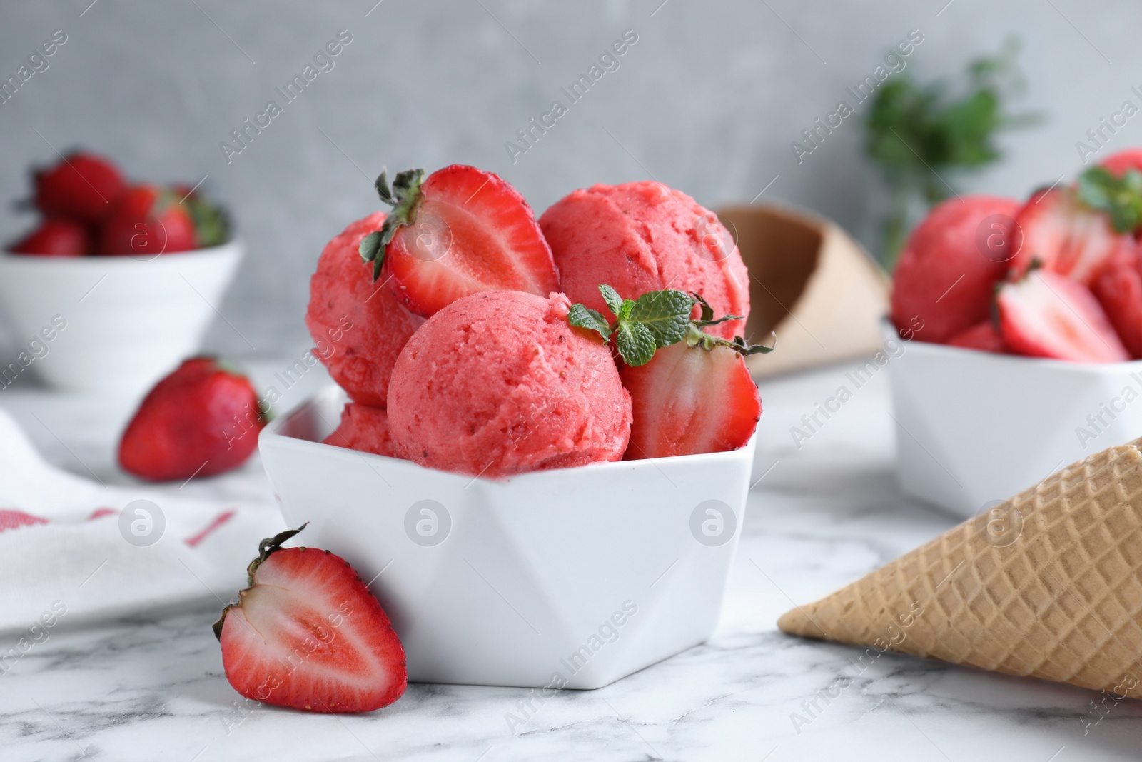 Photo of Yummy strawberry ice cream on white marble table