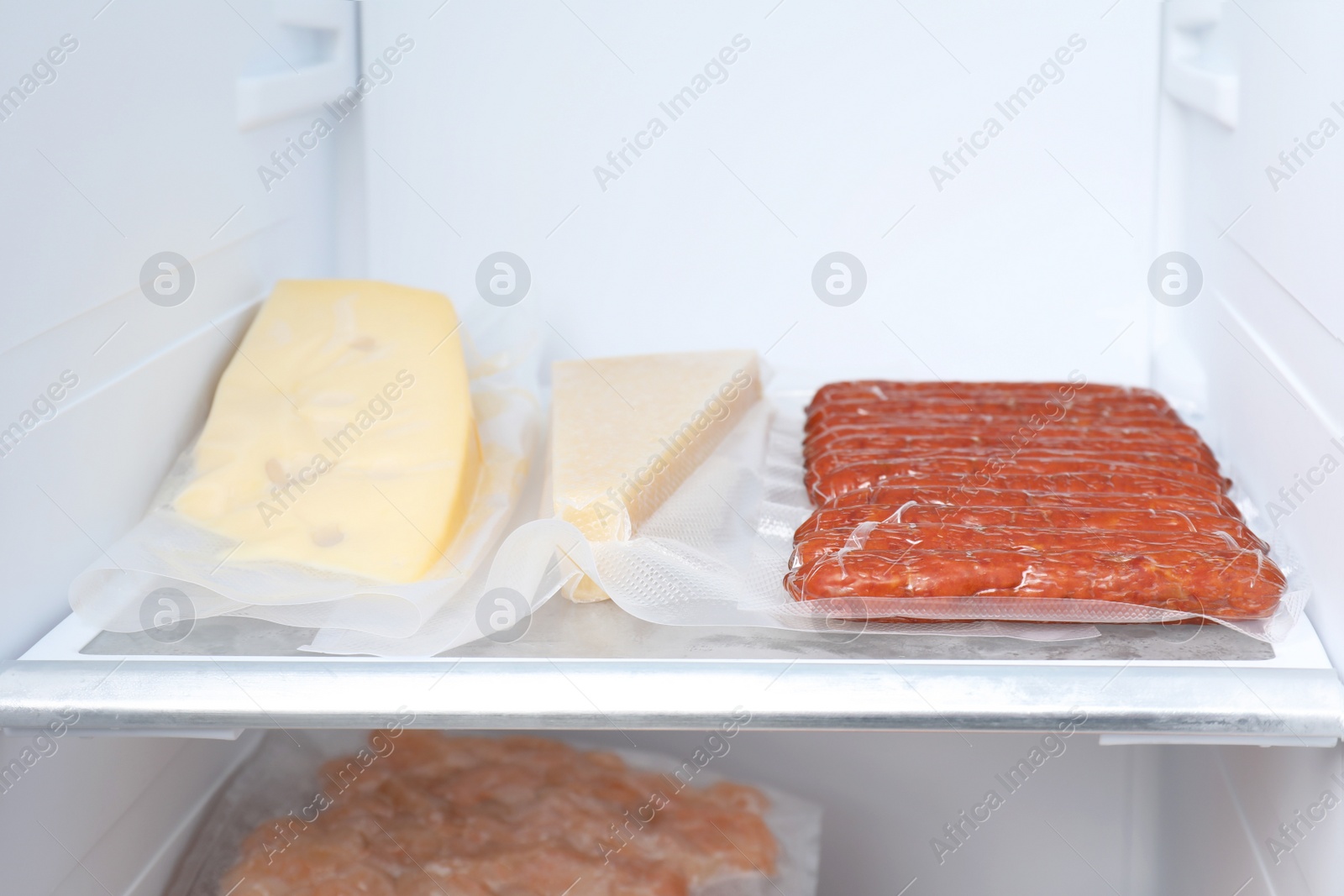 Photo of Vacuum bags with different products in fridge. Food storage