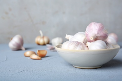 Photo of Plate with fresh garlic bulbs on table