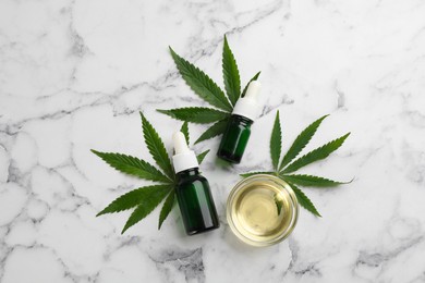 Photo of Hemp leaves, CBD oil and THC tincture on white marble table, flat lay