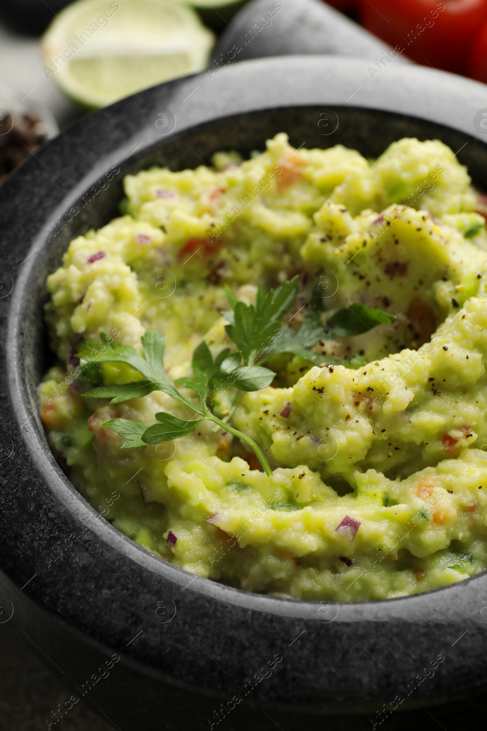 Photo of Mortar with delicious guacamole on table, closeup