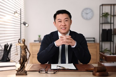 Photo of Happy notary working at wooden table in office