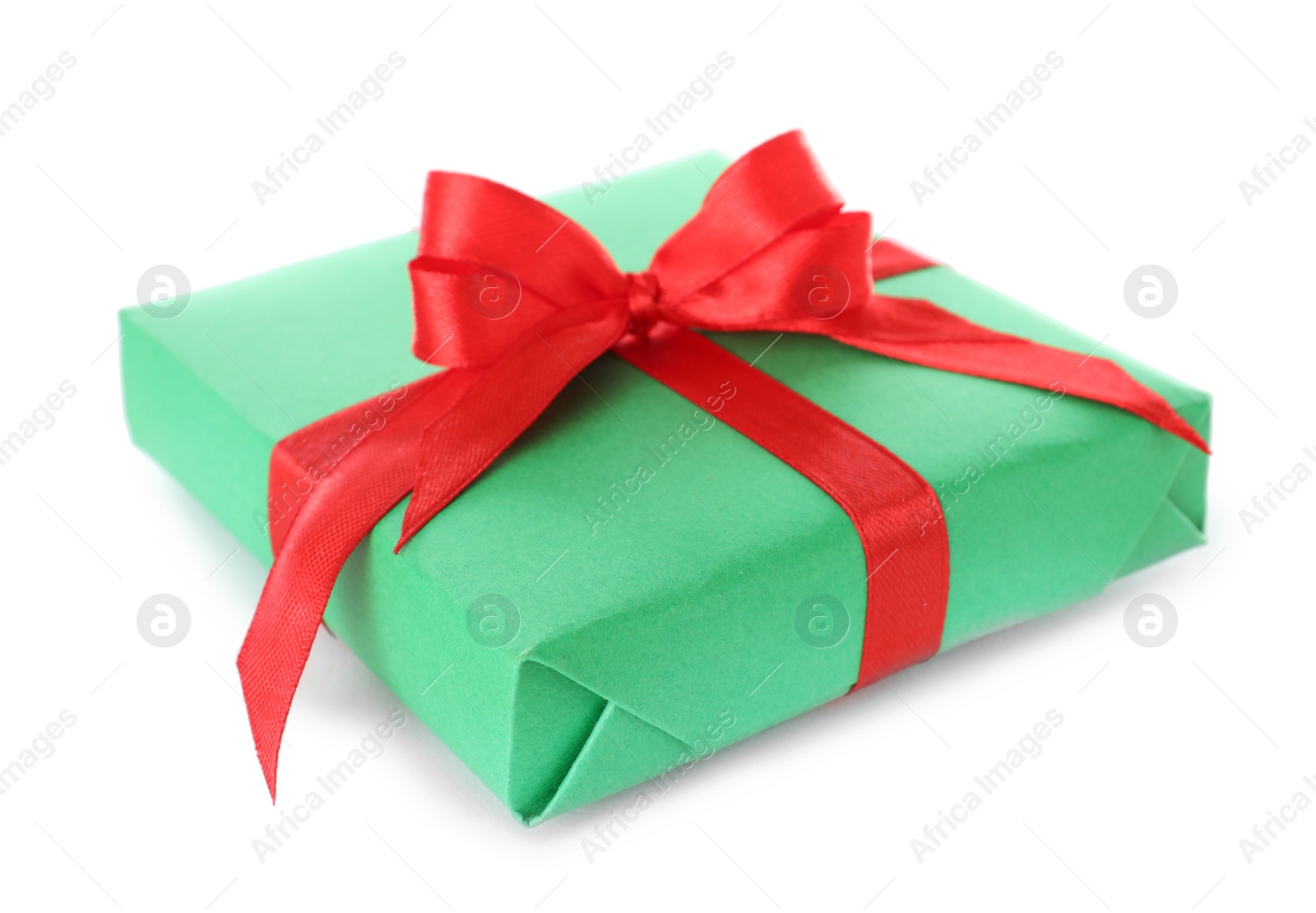 Photo of Christmas gift box decorated with ribbon bow on white background