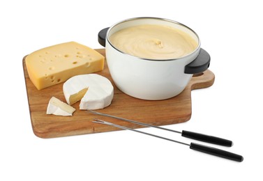 Fondue with tasty melted cheese, forks and pieces isolated on white