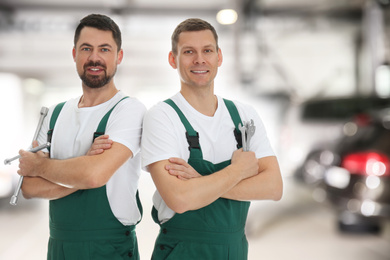 Image of Professional mechanic with tools at tire shop