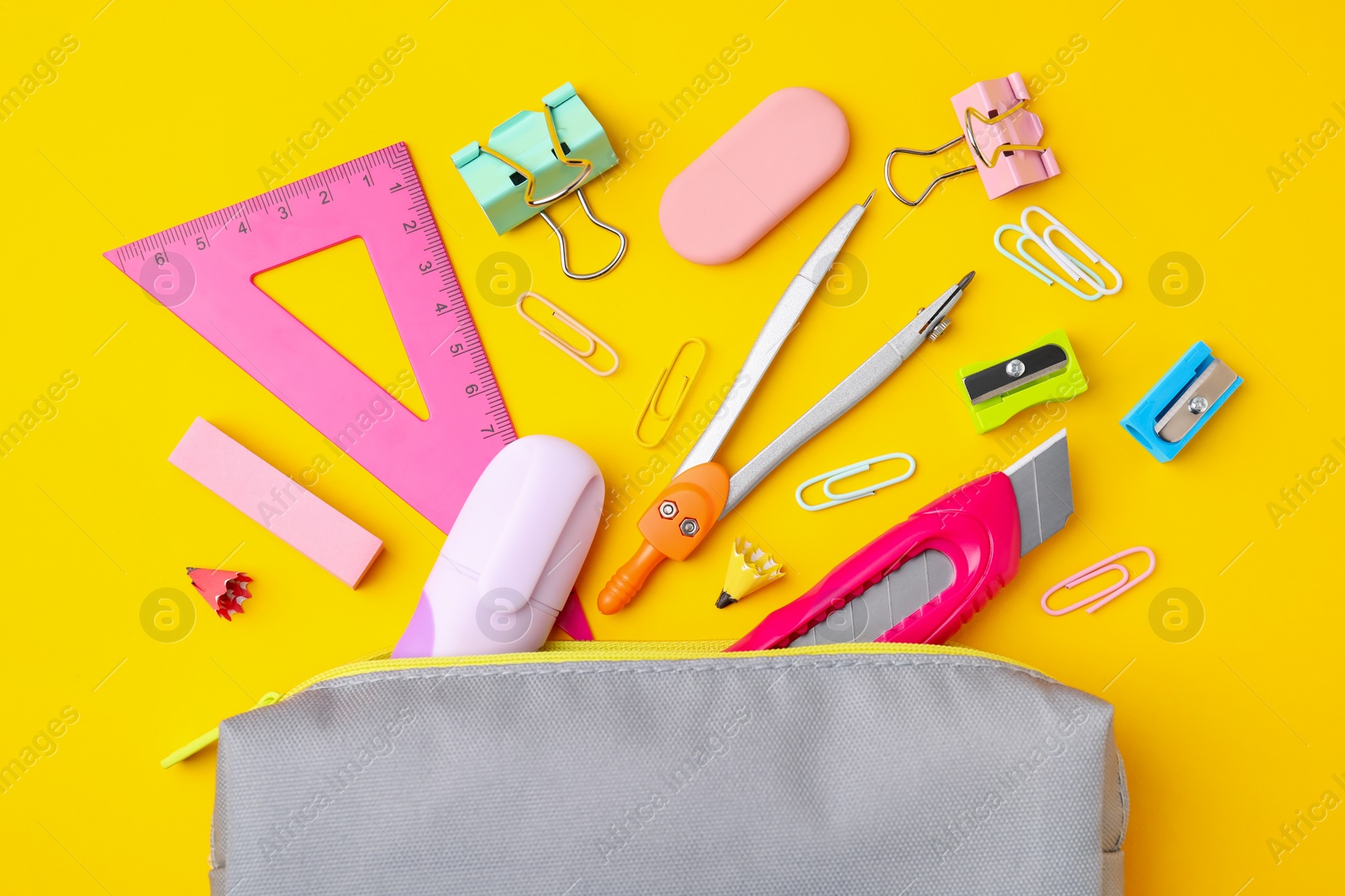 Photo of Flat lay composition with different school stationery on yellow background. Back to school