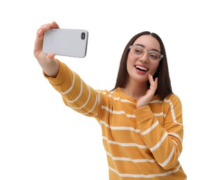 Smiling young woman taking selfie with smartphone on white background