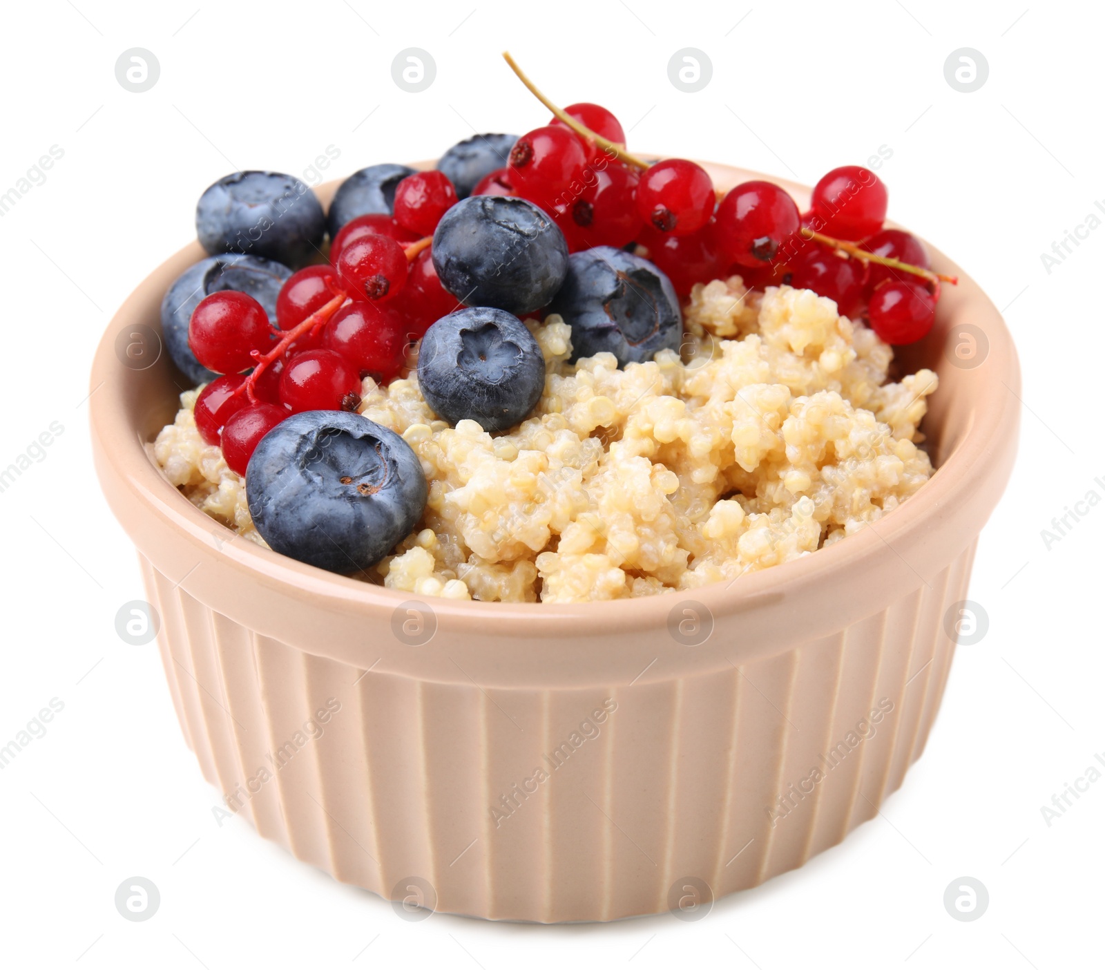 Photo of Bowl of delicious cooked quinoa with blueberries and cranberries isolated on white