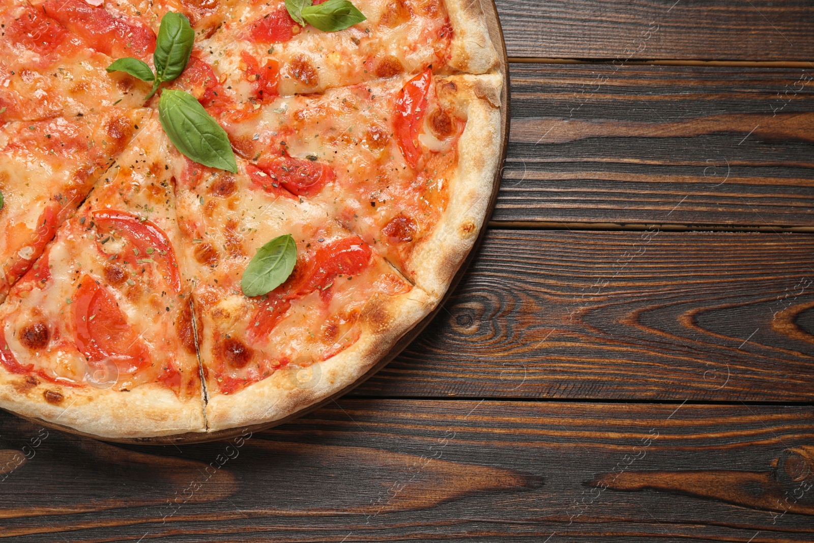 Photo of Delicious pizza Margherita on wooden table, top view. Space for text