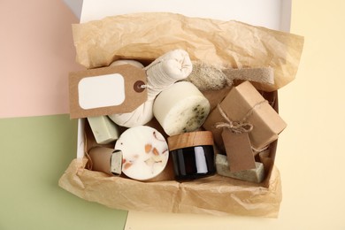 Photo of Box with eco friendly personal care products on color background, top view