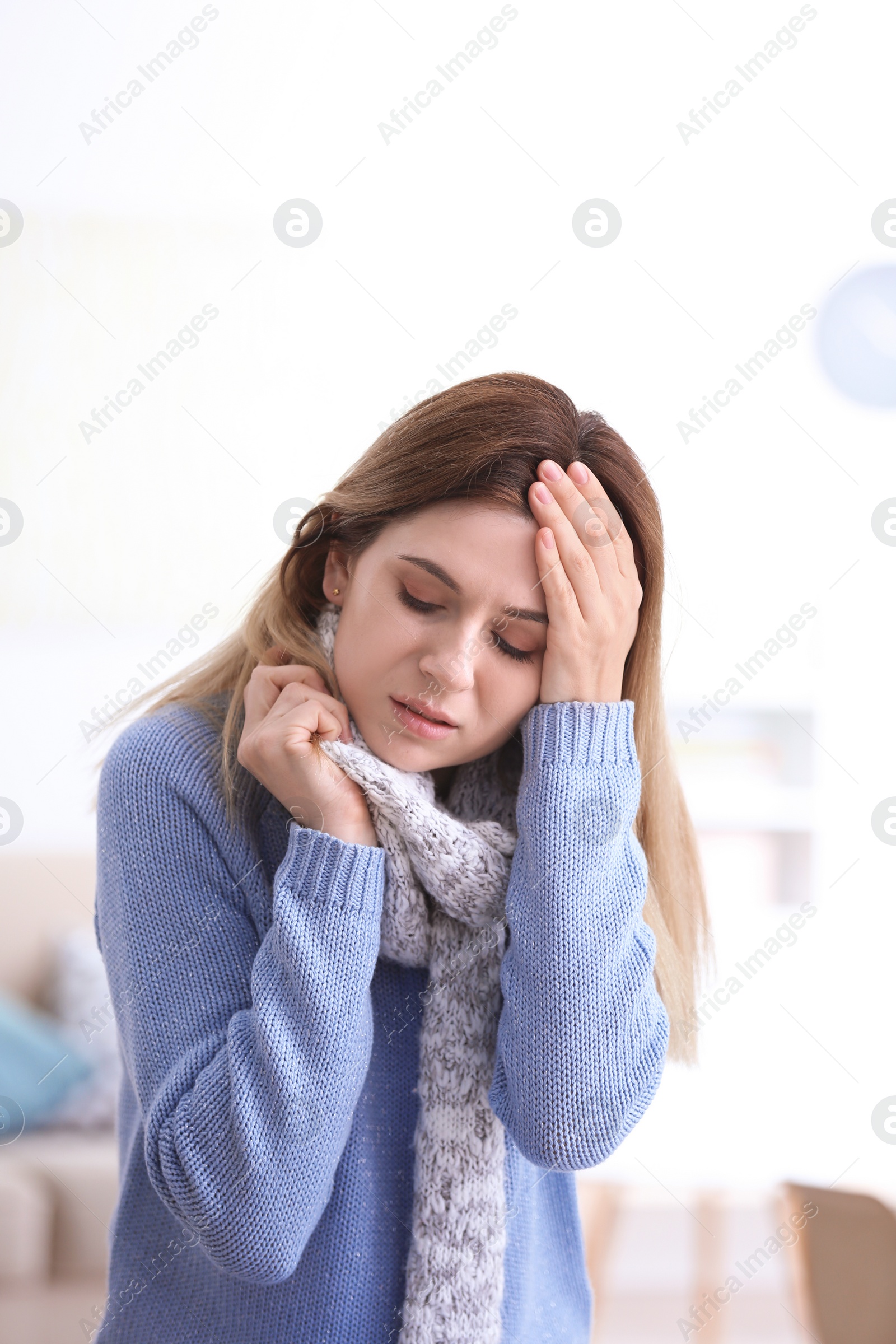 Photo of Woman with headache suffering from cold on blurred background