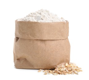 Photo of Paper bag with oatmeal flour and flakes isolated on white