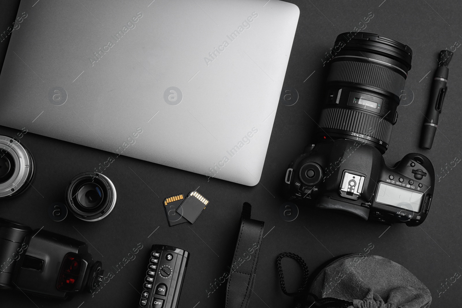 Photo of Flat lay composition with photographer's equipment and accessories on black background