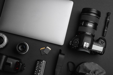 Photo of Flat lay composition with photographer's equipment and accessories on black background