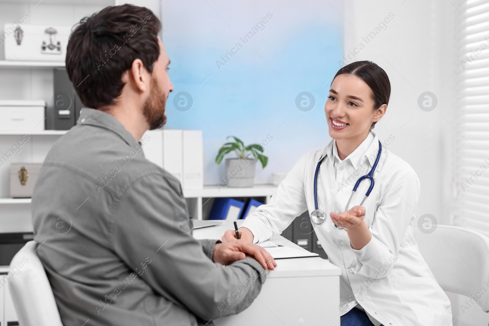 Photo of Doctor consulting patient during appointment in clinic