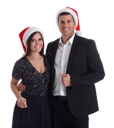 Photo of Beautiful happy couple in Christmas hats on white background