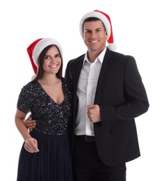 Beautiful happy couple in Christmas hats on white background